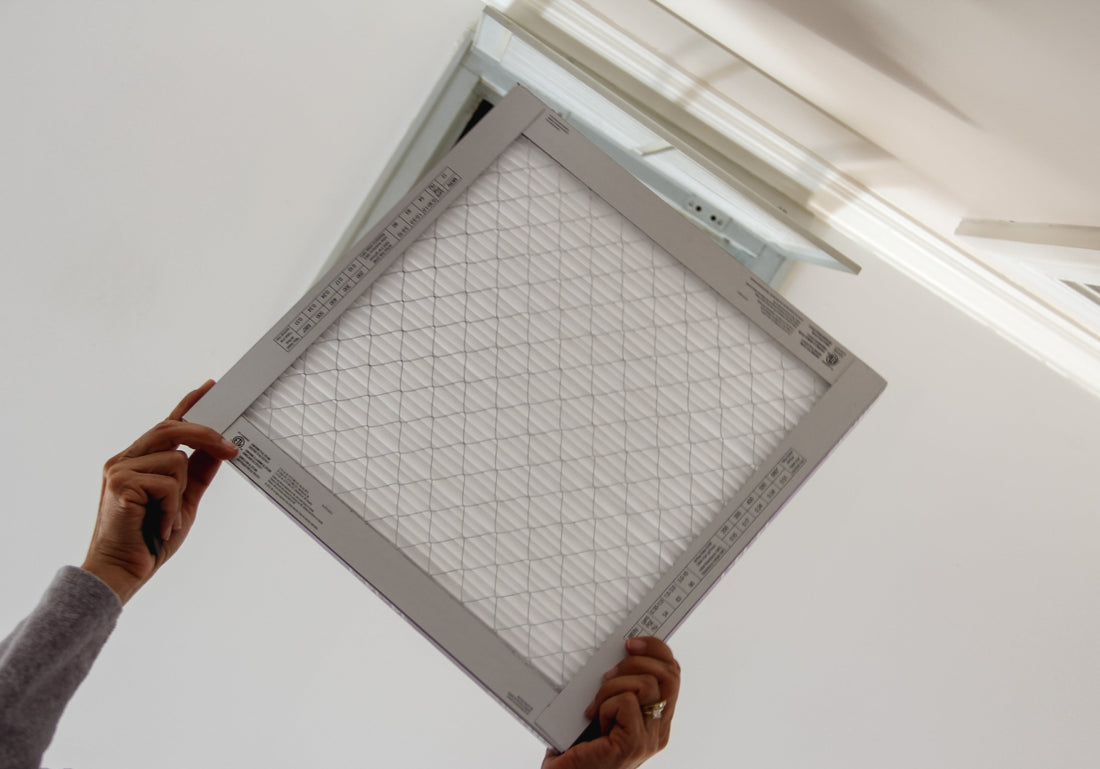 Homeowner woman changing home air conditioning filters since it’s important to do it as recommended