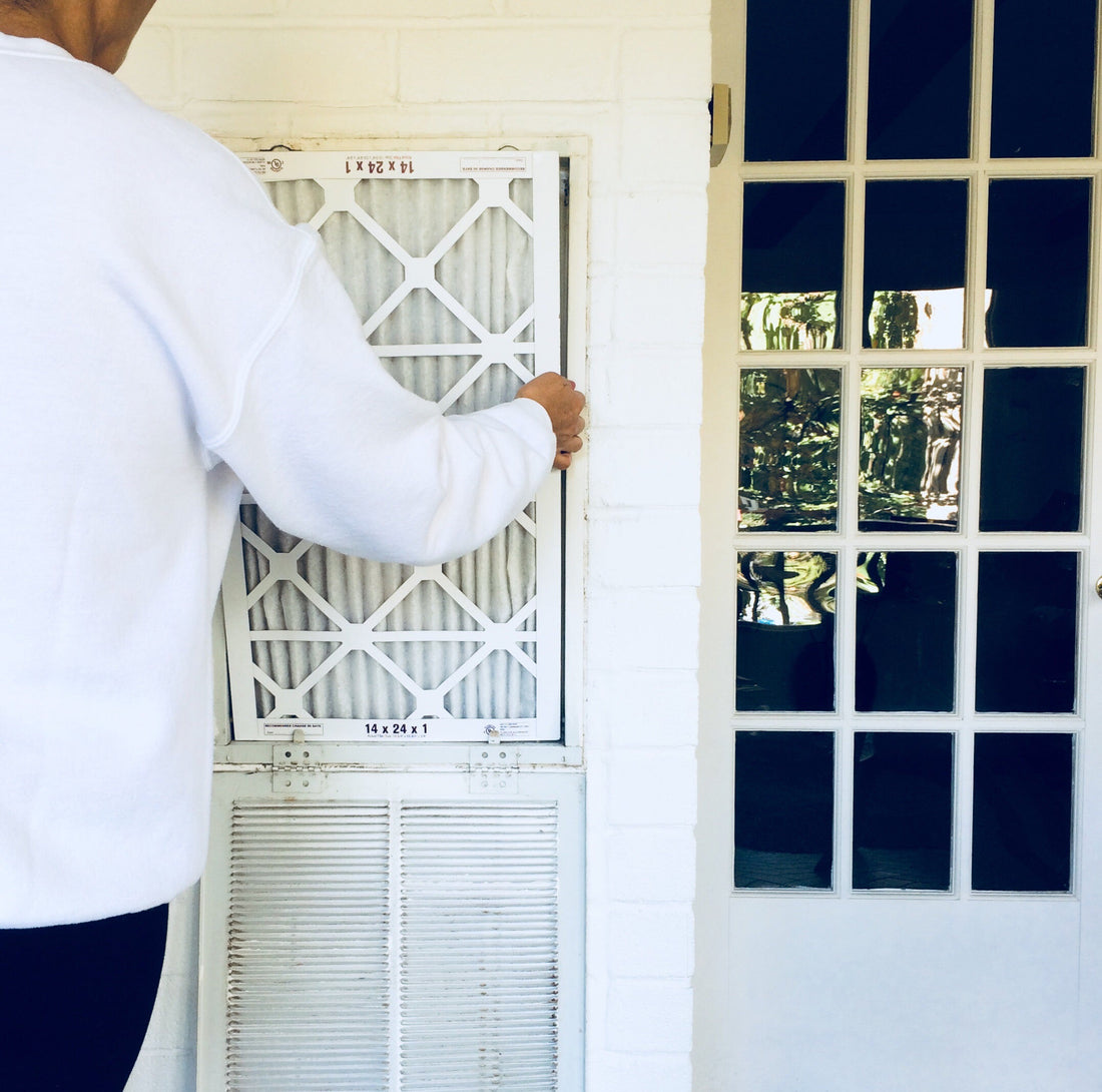 Woman changing home air filters